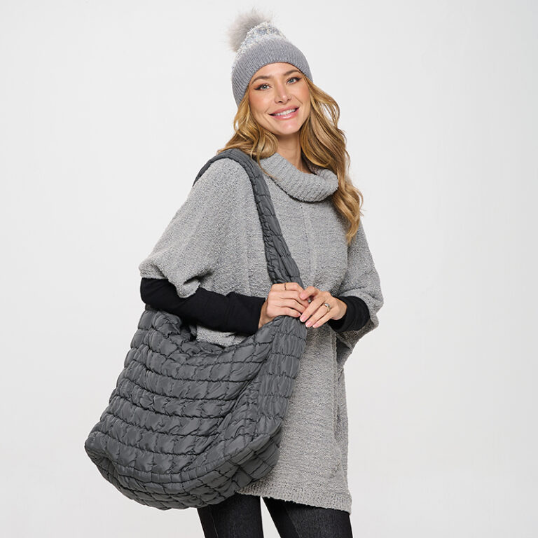 Model with grey bag, sweater and hat